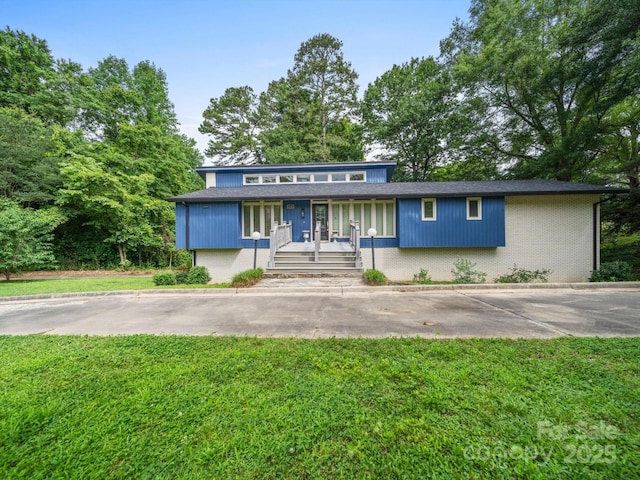 1261 Westbrook Cir, Gastonia, NC 28052 - view of front of home featuring a front yard, a porch, and brick siding