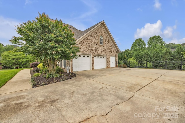 604 Gwendolyn Ct, Granite Falls, NC 28630 - view of side of property with driveway, brick siding, and an attached garage