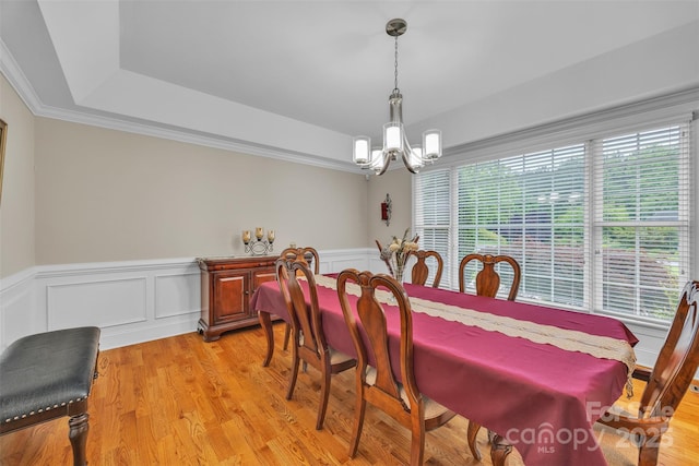 604 Gwendolyn Ct, Granite Falls, NC 28630 - dining area featuring a chandelier, a tray ceiling, light wood-style flooring, wainscoting, and a decorative wall
