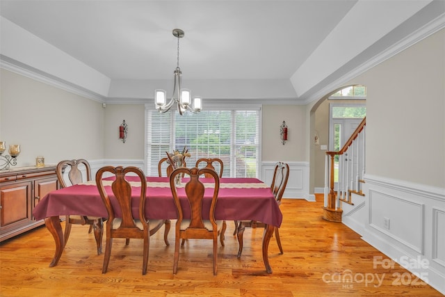 604 Gwendolyn Ct, Granite Falls, NC 28630 - dining area featuring a chandelier, wainscoting, light wood-type flooring, a tray ceiling, and arched walkways