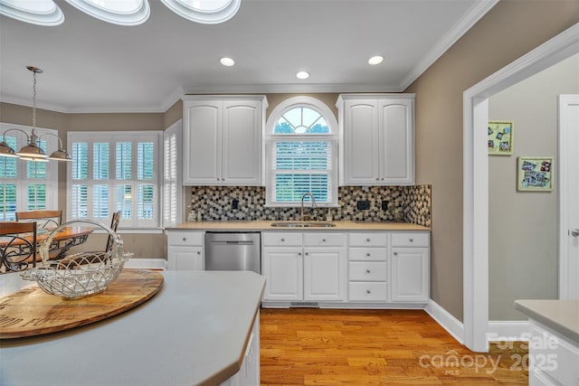 604 Gwendolyn Ct, Granite Falls, NC 28630 - kitchen with dishwasher, crown molding, light wood-style flooring, white cabinets, and decorative light fixtures