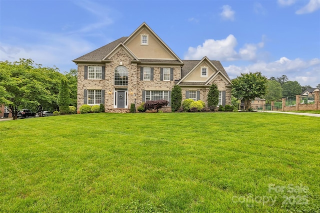 604 Gwendolyn Ct, Granite Falls, NC 28630 - georgian-style home featuring a front yard, stucco siding, and brick siding