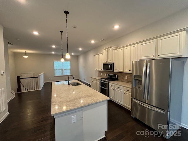 9236 Ainslie Downs St, Charlotte, NC 28273 - kitchen with appliances with stainless steel finishes, a sink, dark wood finished floors, backsplash, and a kitchen island with sink