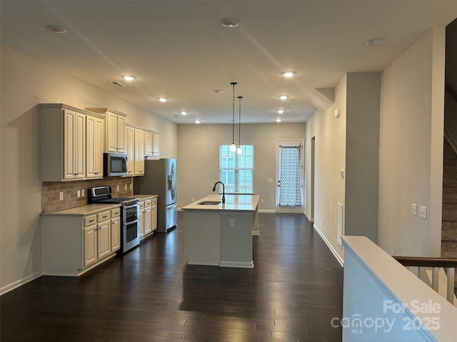 9236 Ainslie Downs St, Charlotte, NC 28273 - kitchen with stainless steel appliances, a sink, dark wood-type flooring, backsplash, and light countertops