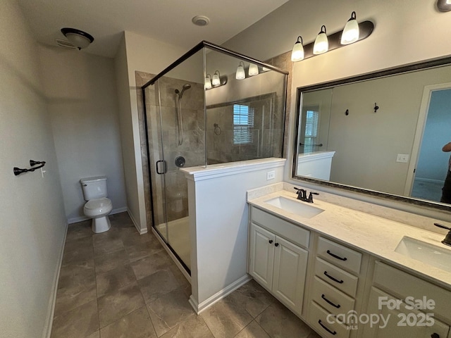 9236 Ainslie Downs St, Charlotte, NC 28273 - full bathroom featuring a shower stall, double vanity, toilet, and baseboards