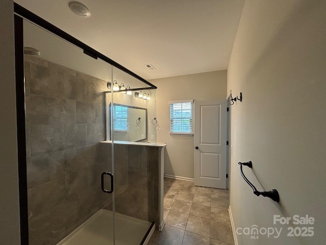 9236 Ainslie Downs St, Charlotte, NC 28273 - bathroom featuring a stall shower, tile patterned floors, baseboards, and vanity