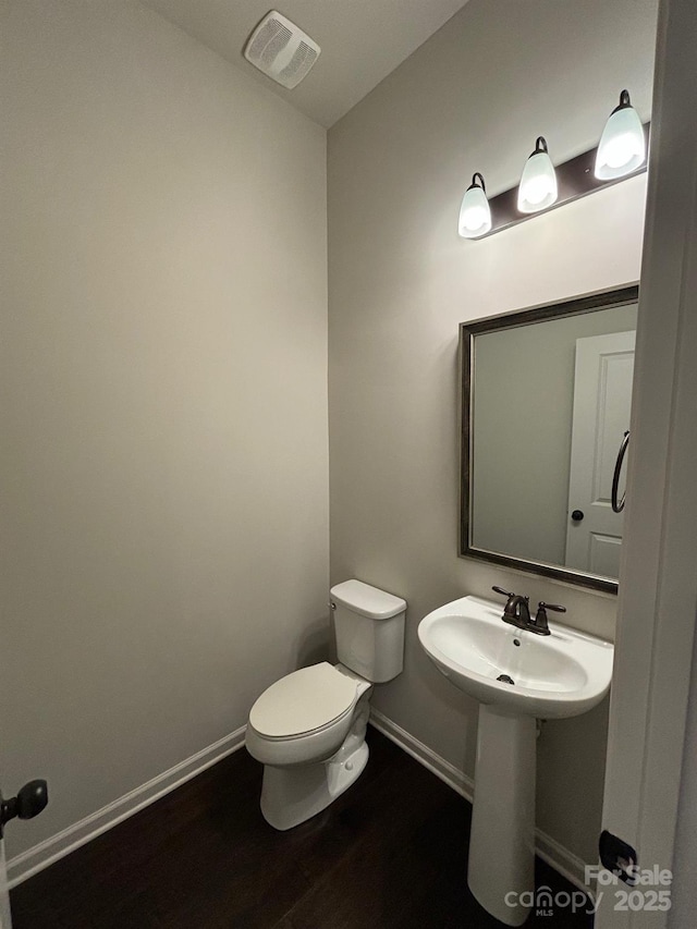 9236 Ainslie Downs St, Charlotte, NC 28273 - bathroom featuring toilet, wood finished floors, and baseboards