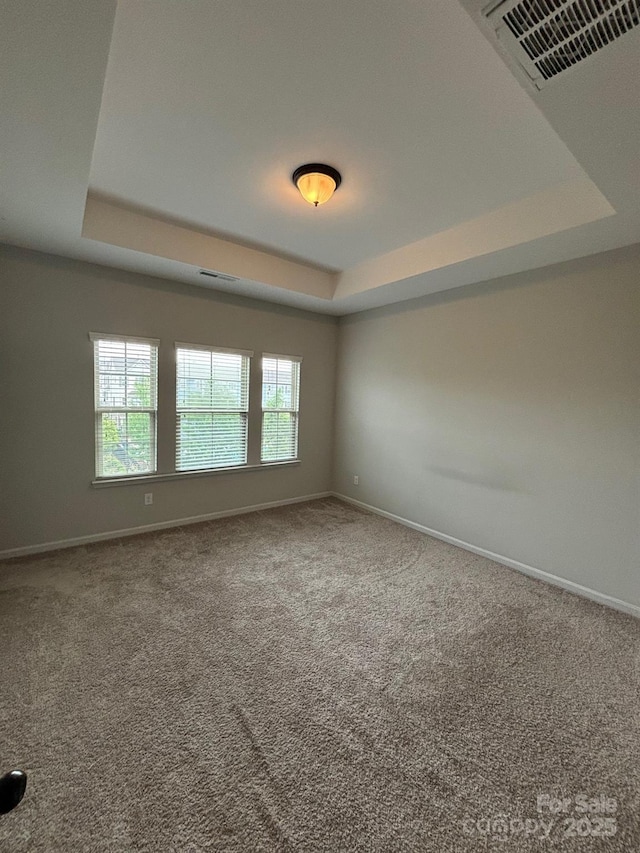 9236 Ainslie Downs St, Charlotte, NC 28273 - carpeted empty room featuring a tray ceiling and baseboards