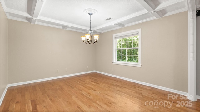 8321 Walkup Rd, Waxhaw, NC 28173 - spare room with coffered ceiling, beamed ceiling, a chandelier, light wood-style flooring, and ornamental molding