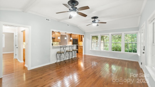 8321 Walkup Rd, Waxhaw, NC 28173 - living area with ceiling fan, wood finished floors, and ornamental molding