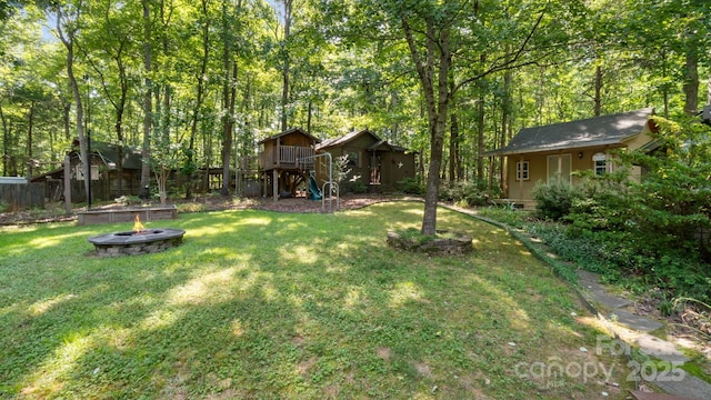 8321 Walkup Rd, Waxhaw, NC 28173 - view of green lawn with a fire pit and an outdoor structure
