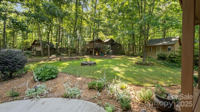 8321 Walkup Rd, Waxhaw, NC 28173 - view of green lawn with a fire pit and a storage shed