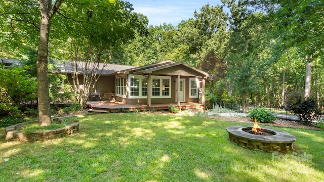 8321 Walkup Rd, Waxhaw, NC 28173 - rear view of property with an outdoor fire pit, a deck, and a wooded view