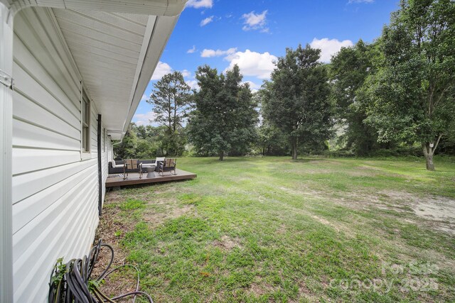 1119 Scott Rd, Kershaw, SC 29067 - view of grassy yard with outdoor lounge area, a deck, and view of scattered trees