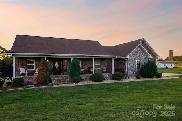 2843 Startown Rd, Lincolnton, NC 28092 - view of front of home with covered porch, a yard, stone siding, and roof with shingles