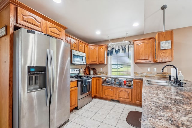 2843 Startown Rd, Lincolnton, NC 28092 - kitchen with appliances with stainless steel finishes, a sink, light tile patterned floors, brown cabinetry, and recessed lighting