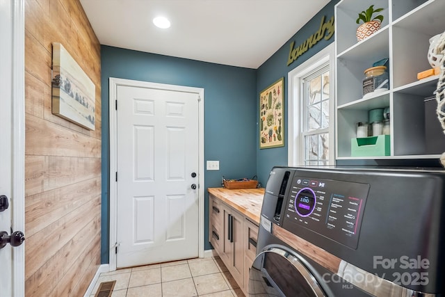 2843 Startown Rd, Lincolnton, NC 28092 - laundry area featuring light tile patterned flooring, washer and dryer, wood walls, and baseboards