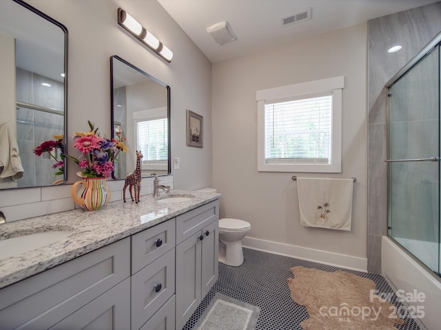 574 Crescent Rd, Rockwell, NC 28138 - bathroom featuring double vanity, toilet, tile patterned floors, combined bath / shower with glass door, and baseboards