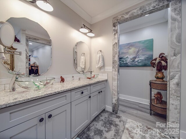 574 Crescent Rd, Rockwell, NC 28138 - bathroom with crown molding, double vanity, wood finished floors, and wainscoting