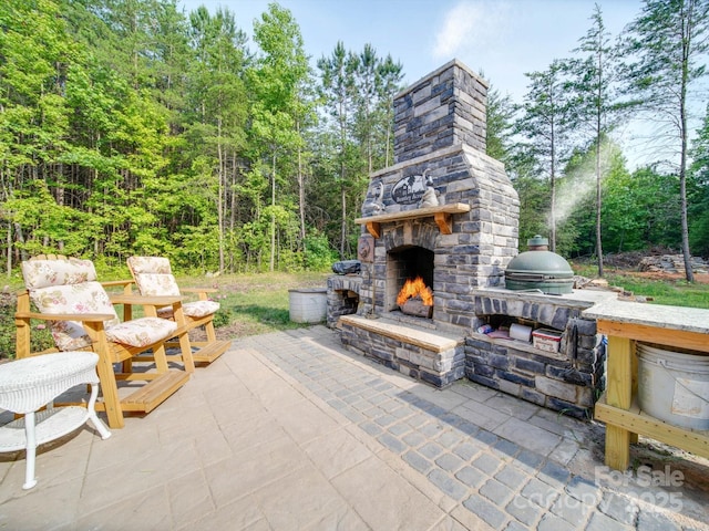 574 Crescent Rd, Rockwell, NC 28138 - view of patio featuring an outdoor stone fireplace and a forest view