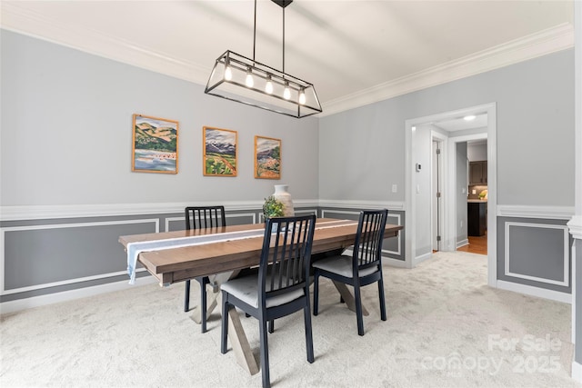 6432 Morningsong Ln, Charlotte, NC 28269 - dining area featuring crown molding, light colored carpet, and wainscoting
