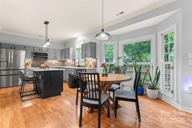 6432 Morningsong Ln, Charlotte, NC 28269 - dining area featuring ornamental molding and light wood finished floors