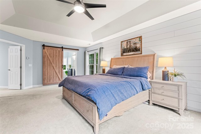 6432 Morningsong Ln, Charlotte, NC 28269 - bedroom with light carpet, a tray ceiling, a barn door, access to exterior, and baseboards