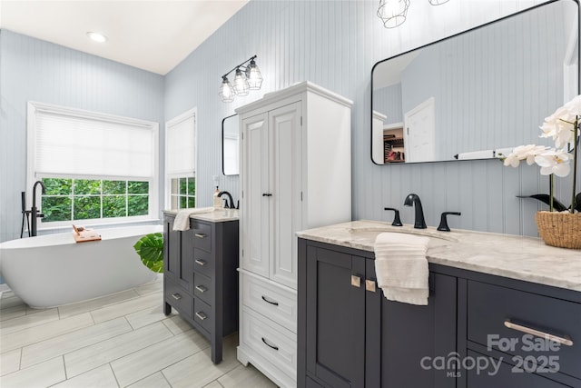 6432 Morningsong Ln, Charlotte, NC 28269 - bathroom featuring two vanities and a freestanding bath