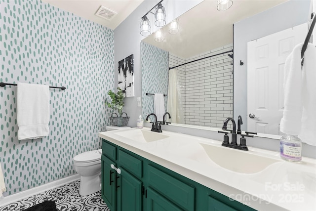 6432 Morningsong Ln, Charlotte, NC 28269 - bathroom featuring wallpapered walls, toilet, double vanity, a tile shower, and tile patterned floors