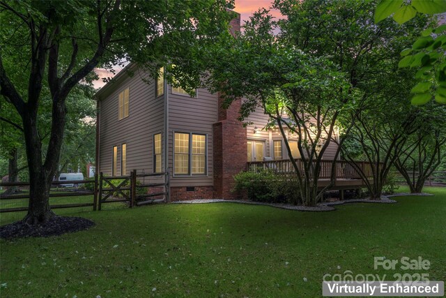 6432 Morningsong Ln, Charlotte, NC 28269 - property exterior at dusk featuring a wooden deck, crawl space, and a gate