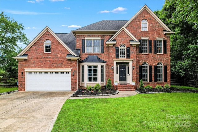 6432 Morningsong Ln, Charlotte, NC 28269 - georgian-style home featuring driveway, brick siding, and roof with shingles