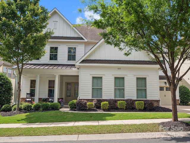 435 Galbreath Ct Unit 128, Fort Mill, SC 29708 - view of front of house with board and batten siding, covered porch, a standing seam roof, a front lawn, and a shingled roof