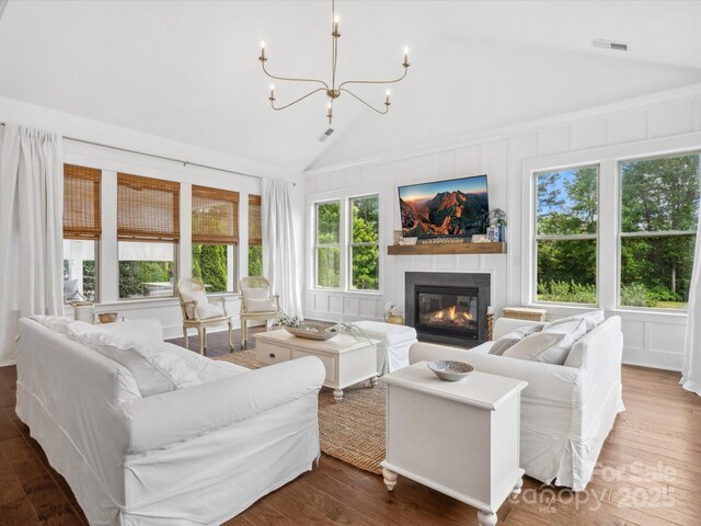 435 Galbreath Ct Unit 128, Fort Mill, SC 29708 - living area featuring vaulted ceiling, a glass covered fireplace, wood finished floors, and a chandelier