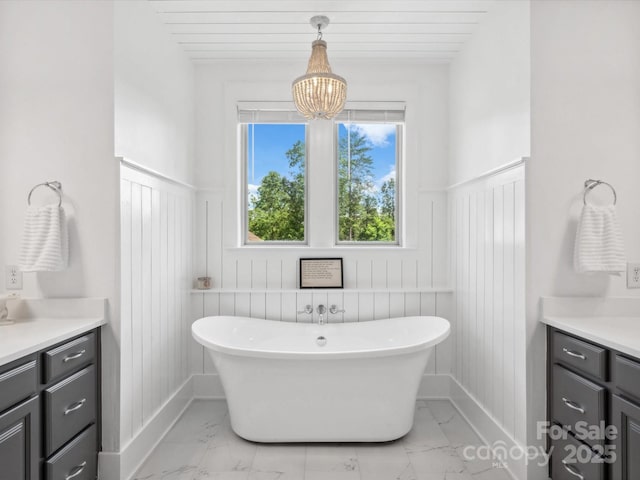 435 Galbreath Ct Unit 128, Fort Mill, SC 29708 - full bathroom featuring vanity, marble look tile flooring, a freestanding bath, wainscoting, and a decorative wall