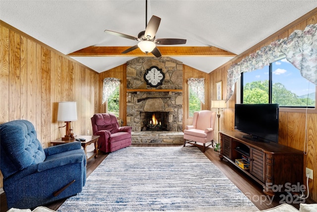 90 Eagles Nest Ln, Maggie Valley, NC 28751 - living area featuring wood walls, plenty of natural light, wood finished floors, vaulted ceiling, and a ceiling fan