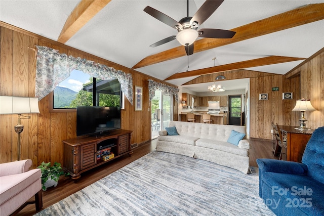 90 Eagles Nest Ln, Maggie Valley, NC 28751 - living room with wood walls, a ceiling fan, and wood finished floors