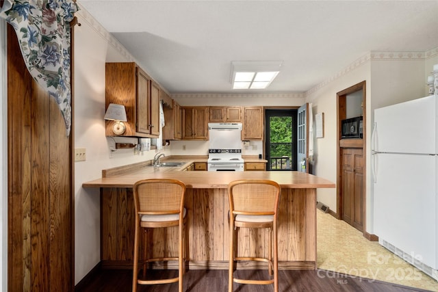 90 Eagles Nest Ln, Maggie Valley, NC 28751 - kitchen with white appliances, range hood, a sink, light countertops, and a peninsula