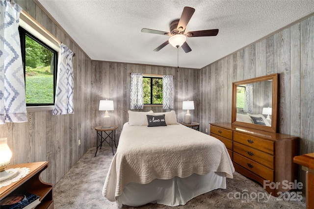 90 Eagles Nest Ln, Maggie Valley, NC 28751 - bedroom featuring a textured ceiling, carpet, wood walls, and ceiling fan