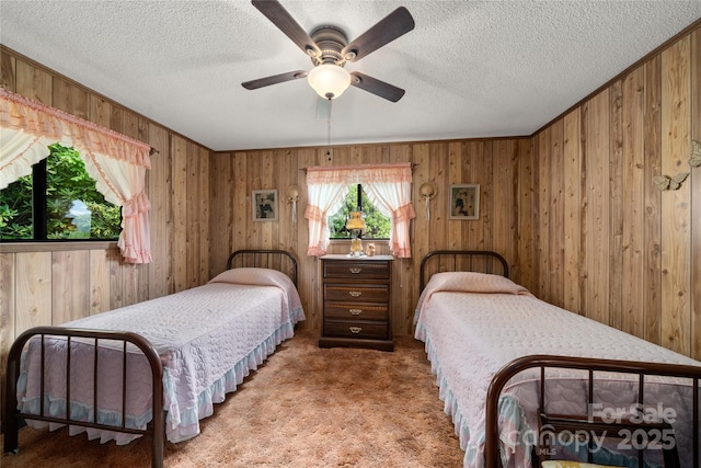 90 Eagles Nest Ln, Maggie Valley, NC 28751 - carpeted bedroom featuring wooden walls, a textured ceiling, and a ceiling fan