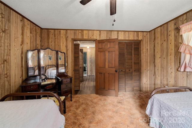 90 Eagles Nest Ln, Maggie Valley, NC 28751 - bedroom with wood walls, ornamental molding, a textured ceiling, a closet, and carpet floors