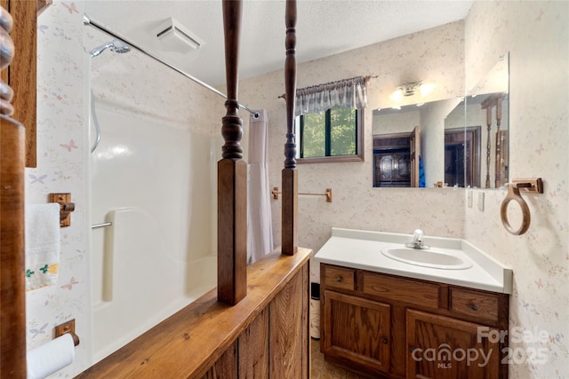 90 Eagles Nest Ln, Maggie Valley, NC 28751 - bathroom with wallpapered walls, vanity, and a textured ceiling