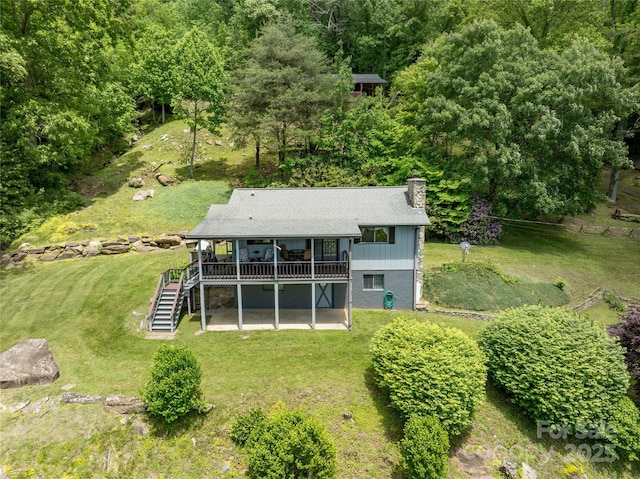 90 Eagles Nest Ln, Maggie Valley, NC 28751 - rear view of house with stairway, a deck, a chimney, a lawn, and a patio area