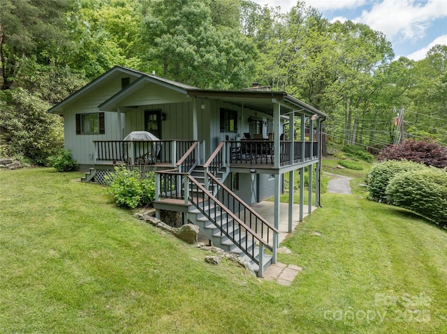90 Eagles Nest Ln, Maggie Valley, NC 28751 - view of front of home with a front lawn, a patio, stairway, and a deck