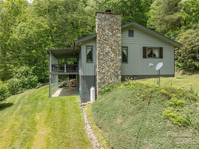 90 Eagles Nest Ln, Maggie Valley, NC 28751 - view of property exterior featuring a lawn, a chimney, a deck, a patio, and a forest view