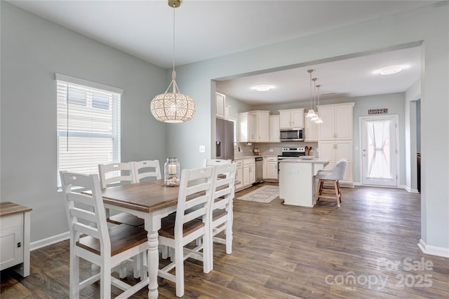 1077 River Haven Ave SW, Concord, NC 28025 - dining area with healthy amount of natural light, baseboards, and dark wood-type flooring