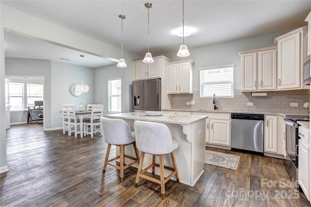 1077 River Haven Ave SW, Concord, NC 28025 - kitchen with appliances with stainless steel finishes, a kitchen island, backsplash, light stone countertops, and dark wood-style flooring