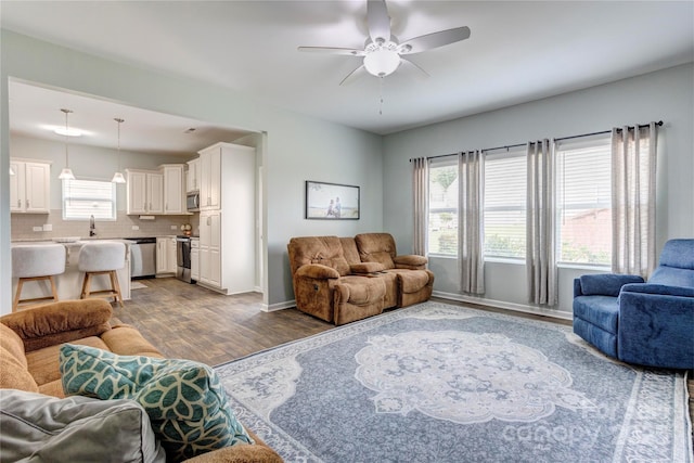 1077 River Haven Ave SW, Concord, NC 28025 - living area featuring light wood finished floors, a ceiling fan, and baseboards