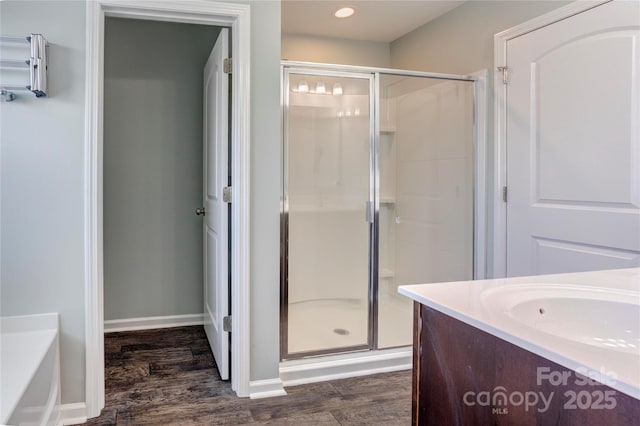 1077 River Haven Ave SW, Concord, NC 28025 - bathroom with a shower stall, wood finished floors, vanity, recessed lighting, and a tub