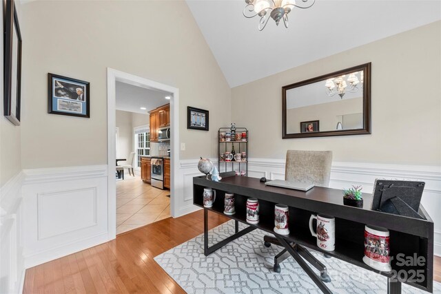 2563 Firethorn Ct, Gastonia, NC 28056 - office area with a chandelier, wainscoting, light wood finished floors, and high vaulted ceiling