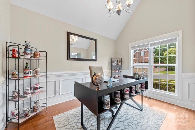 2563 Firethorn Ct, Gastonia, NC 28056 - office area featuring a chandelier, plenty of natural light, a wainscoted wall, wood finished floors, and high vaulted ceiling